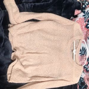 a pink sweater